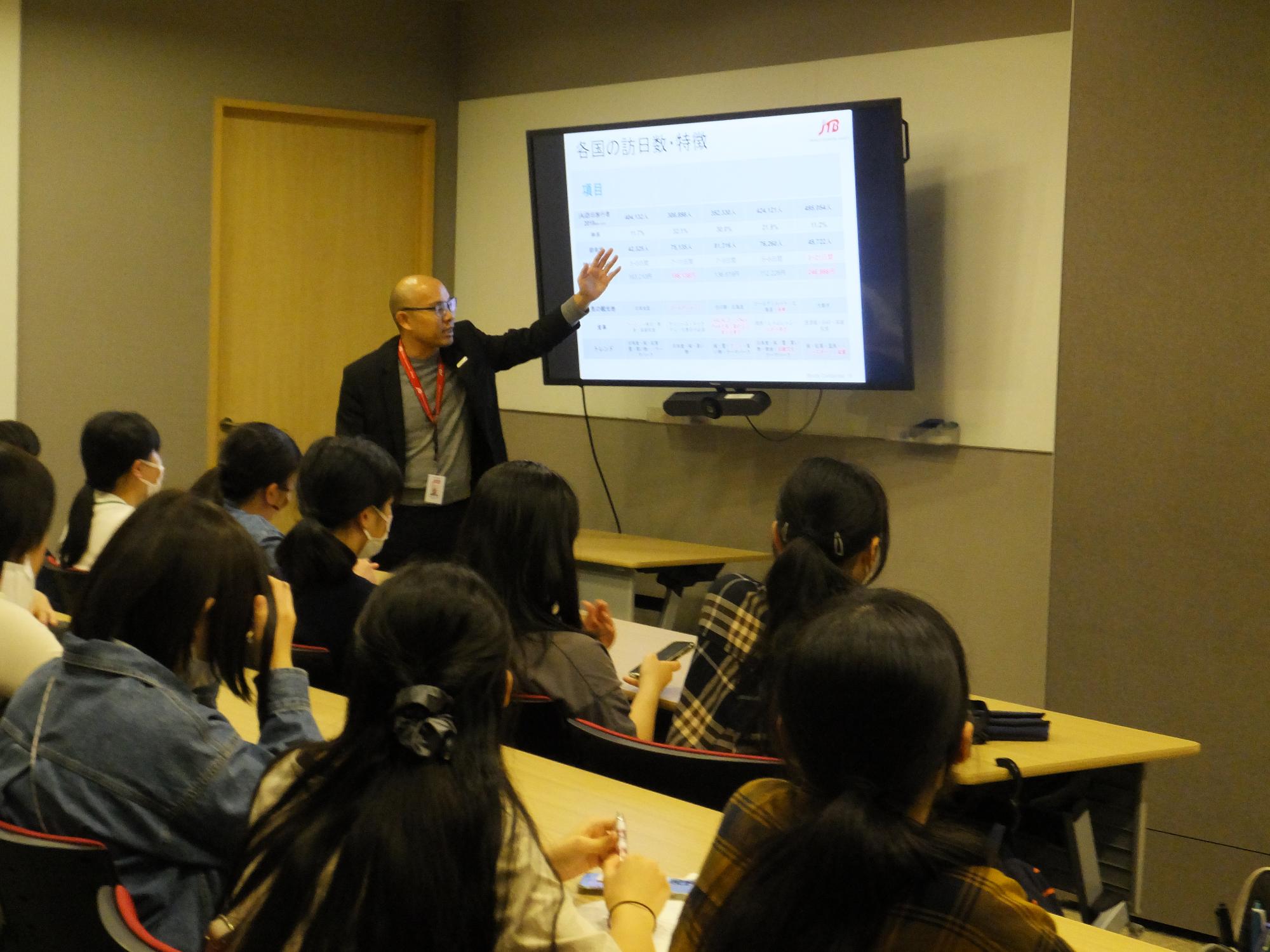 学生が説明を受けている様子の写真