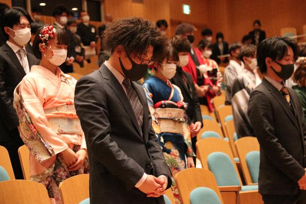 東日本大震災の犠牲者に黙とうを捧げる新成人の写真