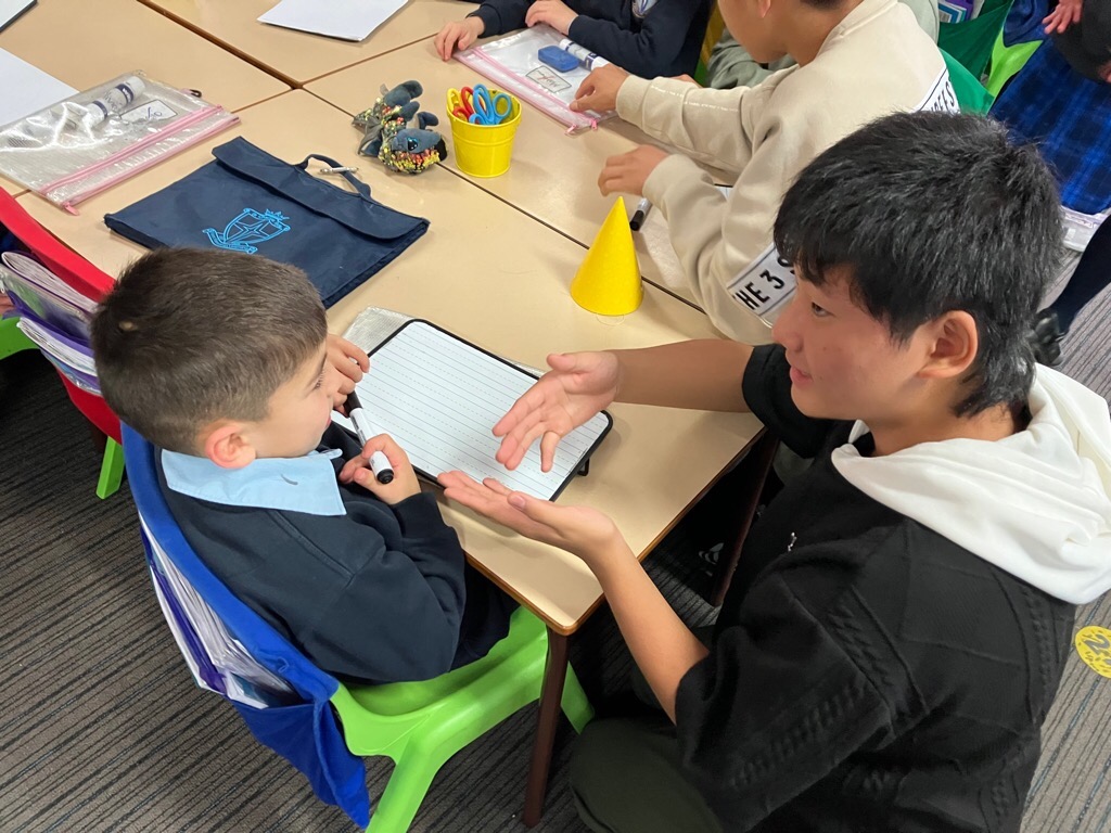 現地校の男子と話す学生の写真